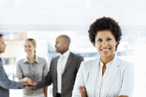 Businesswoman&Colleagues Ambitious African American business woman with her team in discussion at the back
